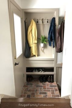 an entryway with tiled flooring and coat racks on the wall, along with shoes