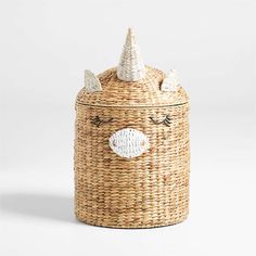 a wicker basket with a fish on the lid and a white hat on top