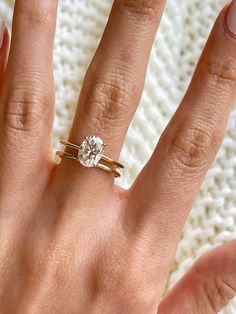 a woman's hand with a ring on it and a diamond in the middle