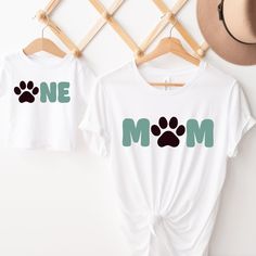 two t - shirts with one mom and one dog's paw prints on them