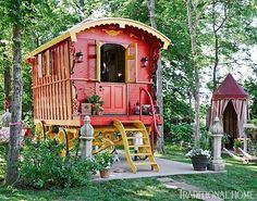 a red and yellow caboose sitting in the woods