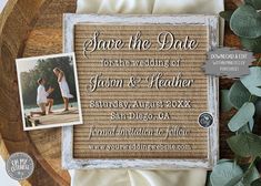 save the date card with photos and greenery on it next to a wooden platter