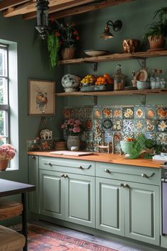 a kitchen with green cabinets and lots of plants on the shelves above the stove top