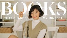 a woman sitting in front of a book shelf with the words books that changed my minds