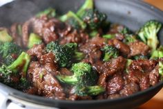 beef and broccoli cooking in a skillet