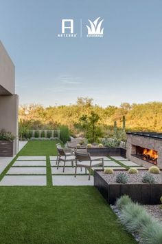 an outdoor living area with grass and fire pit