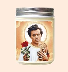 a candle with a painting of a man holding a rose