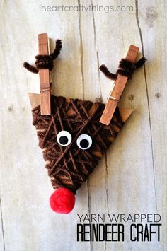 the reindeer craft is made from yarn and wood sticks