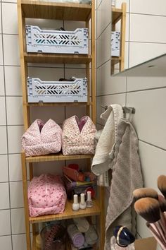 there is a shelf in the bathroom that has many items on it, including shoes