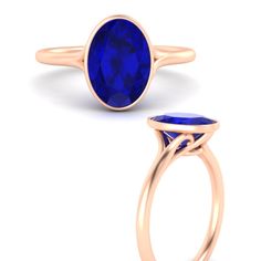 a gold ring with a blue stone in the center and an oval shaped band around it