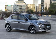 a silver car is parked in front of some buildings