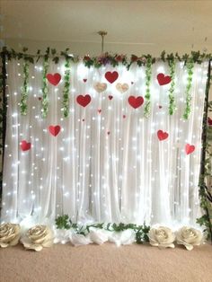 the backdrop is decorated with white roses and greenery for valentine's day celebrations