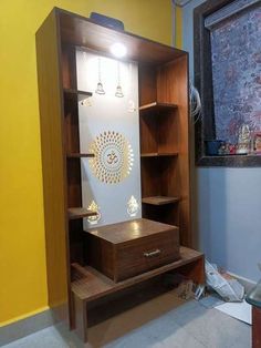 a wooden shelf with lights on it in a room that is painted yellow and white