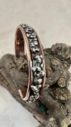 This Sterling Silver and Copper Bracelet is hand forged copper that is 7 1/4" OD inches long and ID  6 1/2 '' and 1/2" inch wide and about 1/4" thick. I use a copper oxide to add a little depth and color to this bracelet. The pure Sterling Silver Components add a nice contrast and texture to this Copper bracelet. I have been wanting to do this for a long time and I am very happy with the results.  I included a Black Cloth Gift Pouch ( my wife's idea )  with a "polish  cloth" for this Solid Silver and copper bracelet. I hope you enjoy it as much as I did making it. Copper Bracelets, Christmas Deals, Copper Bracelet, Gift Pouch, Hand Forged, Bangle Bracelets, Jewelry Bracelets, Handmade Jewelry, Bangles