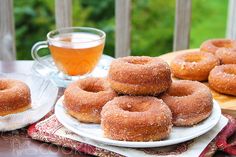 doughnuts and tea on a table outside