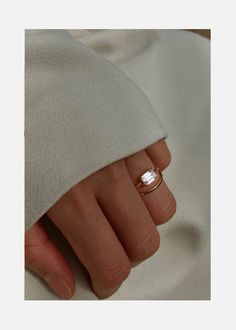 a woman's hand with a ring on it