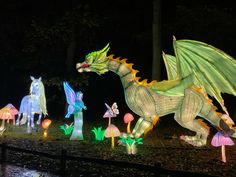 lighted dragon statues in the woods at night