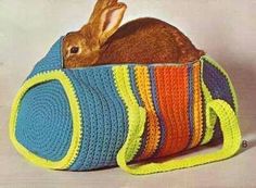 a crocheted bag with a rabbit in it