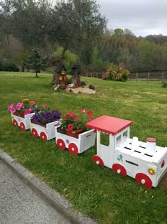 a train shaped planter with flowers in it