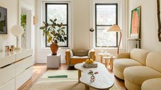 a living room filled with furniture and lots of windows