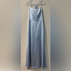 a light blue dress hanging on a hanger