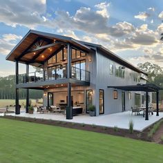 a large house sitting on top of a lush green field