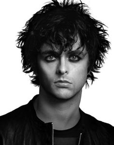 a black and white photo of a young man with dark hair wearing a leather jacket