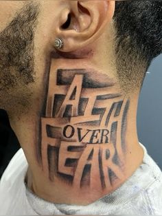 a man with a tattoo on his neck and behind the ear that says faith over fear