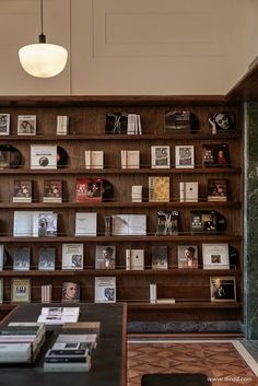 the bookshelf is filled with many different types of books and magazines on it