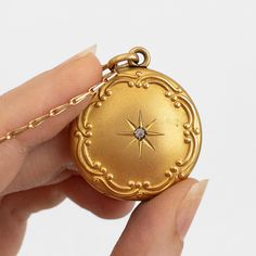 "This antique gold filled Edwardian or Victorian necklace features a photo locket pendant decorated in Art Nouveau repousse of a starburst around a paste gemstone. It hangs on n unusual and seemingly gold plated or filled chain. This item is not marked.   This locket measures about 1 1/8 inches in diameter (not including its bail) while its chain is about 24 inches long. The locket does not have locket frames or covers. It closes with a strong \"snap\"." Gold Heirloom Brass Locket Necklace, Heirloom Gold Brass Locket Necklace, Gold Brass Amulet Locket Necklace, Gold Victorian Round Locket Necklace, Yellow Gold Medallion Locket Amulet Necklace, Yellow Gold Medallion Locket Necklace Amulet, Heirloom Antique Gold Round Locket Necklace, Gold Medallion Jewelry With Vintage Charm, Gold Antique Jewelry For Memorial