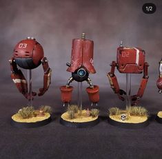 three red robots standing next to each other