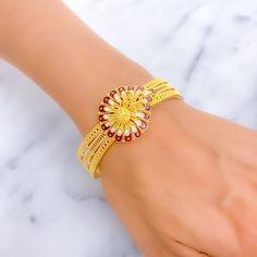 This 22k gold screw bangle, weighing 30.1 grams, showcases a vibrant enameled paisley flower design, offering a splash of color against the classic yellow gold finish. The bangle size is 2.5 inches with a 2.3-inch opening diameter, featuring a secure screw and hinge mechanism for ease of wear. This piece is perfect for adding a festive and artistic touch to any outfit, blending traditional paisley patterns with modern enamel coloring techniques. PRODUCT DETAILS Gold Purity(karat): 22k Gold Weigh Yellow Gold Meenakari Bangle As Gift, Yellow Gold Meenakari Bangle For Gifts, Yellow Gold Meenakari Bracelets As Gift, 22k Gold Meenakari Bracelets As Gift, Traditional Flower Shaped Bracelets, Yellow Gold Bangle For Diwali Gift, Fusion Style Yellow Gold Bangle As A Gift, Gold Flower Bangle, Gold Floral Jewelry For Festivals