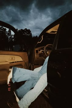 a person laying on the back of a car