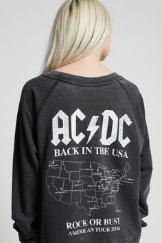 Make a bold statement in style with our AC/DC Back In Black sweatshirt. This hard rock style features one of the band's most iconic albums, "Back In Black" on the front and tour graphics on the back. Our oversized sweatshirt is finished with soft vintage washed fabric, a relaxed crew neckline, and ribbed hems. The design of this style is oversized. For a more standard fit, choose a size down. Details Style #302389 Color: Black AC/DC Back In Black Tour Oversized Sweatshirt Keyword: ACDC 47.5% Pol Black Cotton Sweatshirt With Band Merch, Acdc Shirt Aesthetic, Ac Dc Tshirt, Acdc Sweatshirt, Womens Acdc Shirt, Rolling Stones Shirt, Back In Black, Classic Rock And Roll, Dc Travel