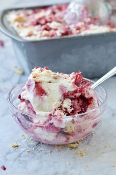 a bowl filled with ice cream and strawberries