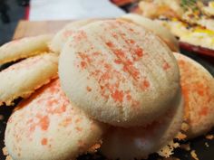 some cookies are sitting on a plate with orange sprinkles