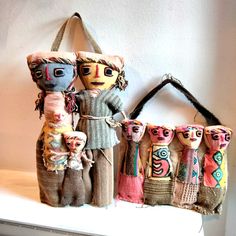 several dolls are hanging on the wall with their heads turned to look like they have been made out of fabric