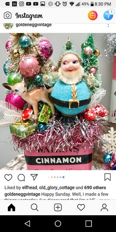 an image of a christmas tree with ornaments and decorations on it's display shelf