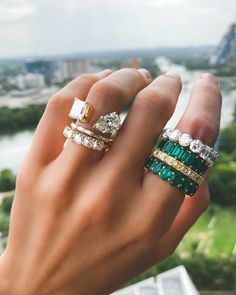 a woman's hand with two rings on top of her finger and one ring in the middle