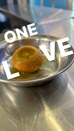 a small donut sitting on top of a metal plate