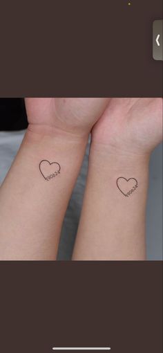 two people with matching tattoos on their arms