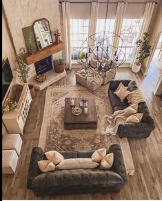 an aerial view of a living room with two couches and a large rug on the floor