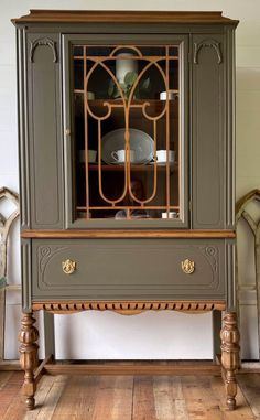 an antique china cabinet with glass doors