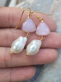 These elegant gold pink faceted crystals and  big baroque pearls earrings are  great for everyday use, parties, or for special occasions! It is made with big genuine baroque pearls, wire wrapped in gold filled wires, measures 9mm to 12 mm x 15mm to 17mm (big baroque, light). The color is natural white, pearls are lustrous. The pearl is attached to a pink crystal glass connector bezel gold rhodium plated connector.  Material: Genuine Baroque Pearls, lustrous, wrinkled Size: 9mm to 12 mm x 15mm to 17mm Finding: gold plated ; pink crystal bezel connector. Length ( with ear hooks) is around 2 inches (  50 mm ). Note: Your jewelry will arrive beautifully and carefully packaged in a gift box with a pretty ribbon. Pink Briolette Earrings For Wedding, Pink Natural Stones Wedding Earrings, Wedding Pink Earrings With Natural Stones, Pearl Teardrop Crystal Earrings As Gift, Teardrop Pearl Crystal Earrings As Gift, Teardrop Pearl Crystal Earrings For Gift, Elegant Pink Faceted Earrings, Pink Pear-shaped Jewelry With Matching Earrings, Pink Baroque Pearl Jewelry For Wedding