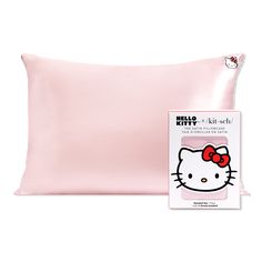 the hello kitty pillow case is pink and has a red bow on it's head