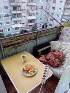 a plate of food sitting on top of a wooden table next to a cup of coffee