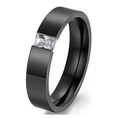 a black wedding ring with a princess cut diamond