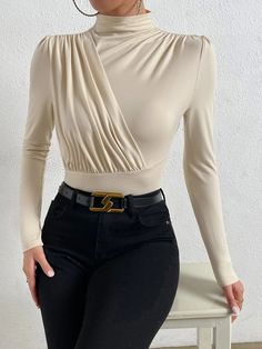 Introducing our stylish and chic Mock Neck Ruched Bodysuit - a must-have for any fashion-conscious woman who wants to make a statement. This elegant bodysuit is made of high-quality knitted fabric that offers superior comfort and flexibility. The slim-fit design features a stand collar and long sleeves that add a touch of sophistication to your wardrobe. The mock neck design highlights your neck and adds a refined touch to your outfit. Features: Color: Apricot Style: Elegant Pattern Type: Plain Type: Tee Neckline: Stand Collar Details: Wrap Sleeve Length: Long Sleeve Sleeve Type: Regular Sleeve Waist Line: Natural Fit Type: Slim Fit Fabric: High Stretch Material: Knitted Fabric Composition: 95% Polyester, 5% Elastane Care Instructions: Machine wash or professional dry clean Sheer: No Featu Chic Stretch Bodysuit, Chic Solid Color Bodysuit For Night Out, Elegant Solid Color Bodysuit For Spring, Elegant Solid Color Bodysuit For Night Out, Chic High Stretch Beige Tops, Chic Beige High Stretch Top, Chic Fitted Solid Color Bodysuit, Fitted Long Sleeve Ruched Bodysuit, Elegant Stretch Bodysuit Solid Color