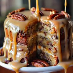 a bundt cake with pecans and caramel drizzled on top