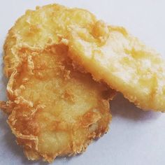 two pieces of fried food sitting on top of a table